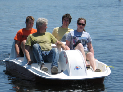 Adventure Glass 6 Person 4 peddler SeaVenture Paddle Boat with four people paddling