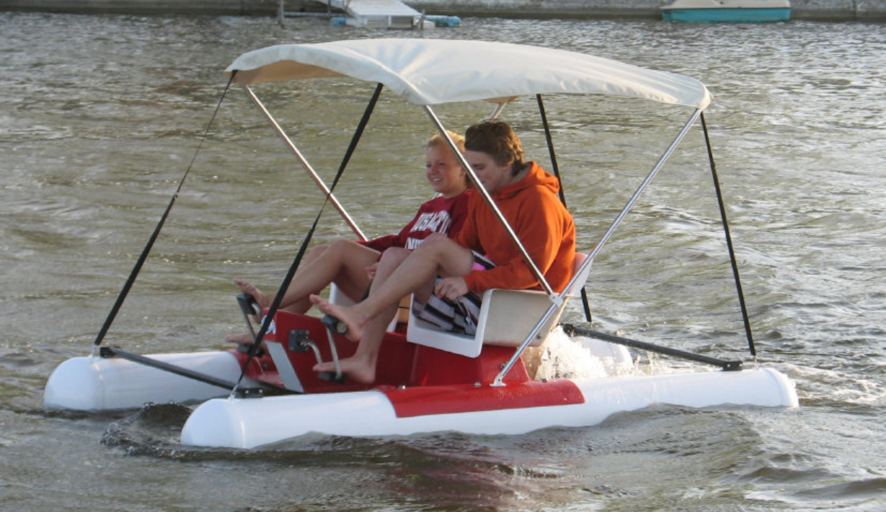 two people enjoying the water with the Adventure Glass Pontoon Paddle Boat