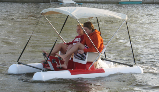 two people enjoying the water with the Adventure Glass Pontoon Paddle Boat