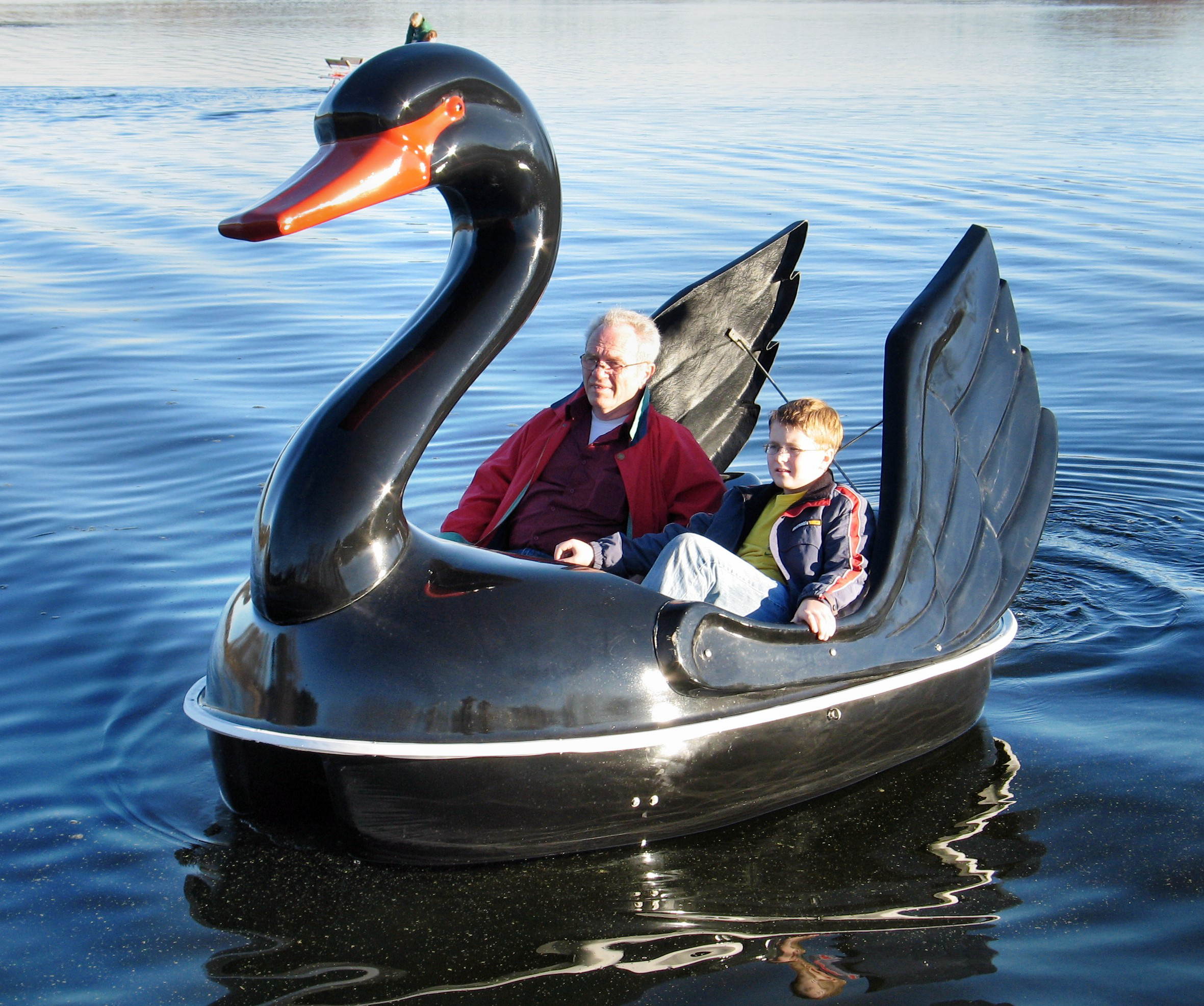 two people enjoying the water with the Adventure Glass Swan Classic 2 Person Paddle Boat