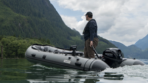 Man driving the Swellfish Classic 390 Inflatable Boat  (12'10") with the Tohatsu Motor