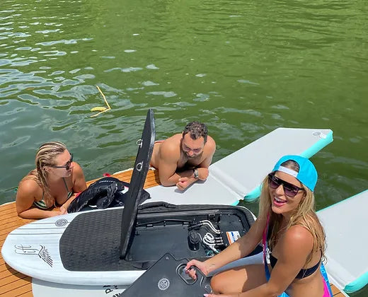 Man and women checking the efoil on the ParadisePad Hydrofoil Docking Station