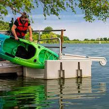 Load image into Gallery viewer, Woman carrying her kayak near the Connect-A-Dock YAKport® Kayak Launch