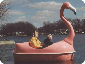 woman with kid riding the Adventure Glass Pink Flamingo Classic 2 Person Paddle Boat