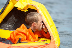 Man inflating the Switlik Inflatable Single Place Life Raft