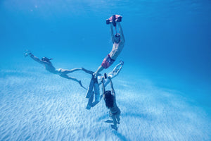 People underwater with the Sublue WhiteShark Mix Underwater Scooter