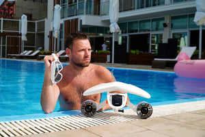 Man on the pool with the Sublue WhiteShark Mix Underwater Scooter