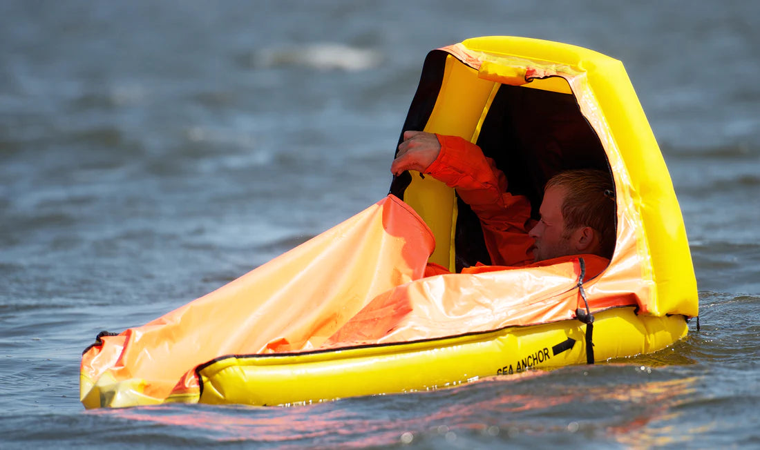 Switlik Inflatable Single Place Life Raft on a half closed with man inside