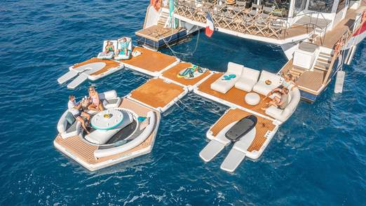 Yachtbeach Pavilion  Table with 74.80" Base in a lounge setup behind the yacht.