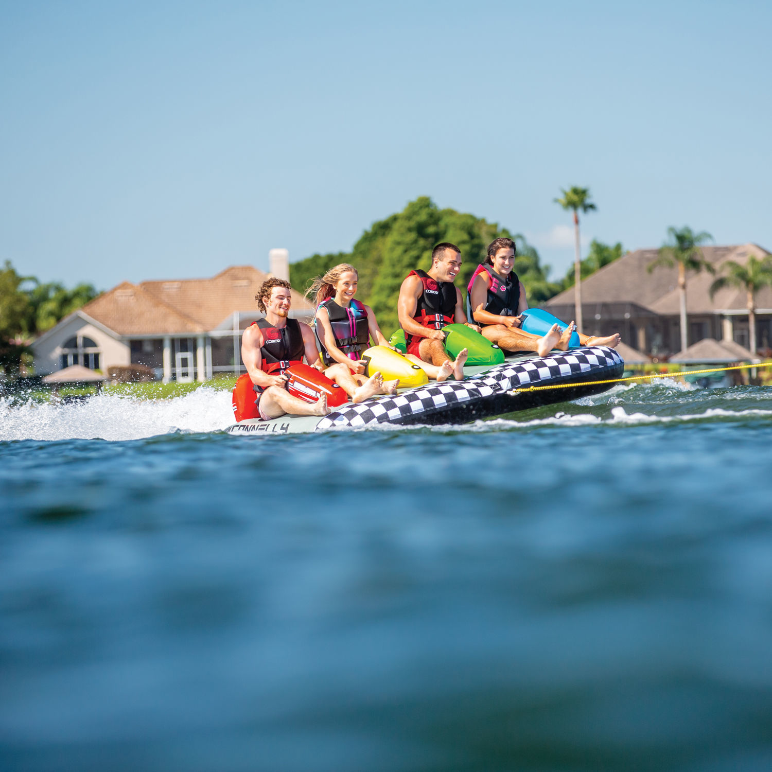 4 People Having Fun Riding On Connelly Daytona 4 Rider Towable
