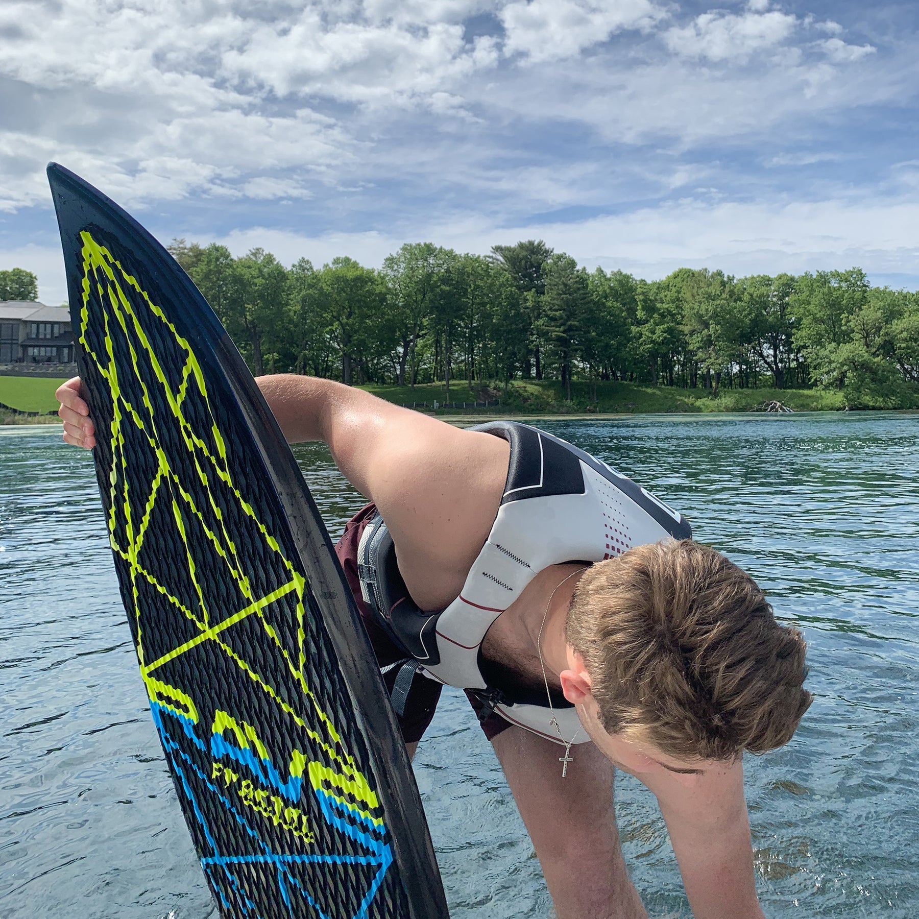 Rave Sports Fractal Wake Surf Board with a man holding on it.