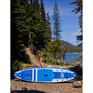 Inflatable Stand Up Paddleboard - Woman standing beside the California Board Company Viking iSUP 