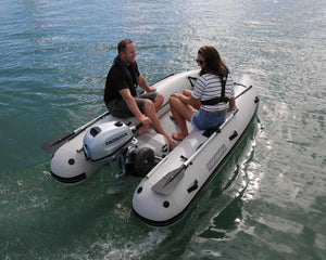 Man and woman riding the Takacat T300LX Inflatable Boat