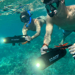 Scuba Jet Accessory - Man and Woman controlling the the ScubaJet with the Scuba Jet DHC - Dual Hand Controller