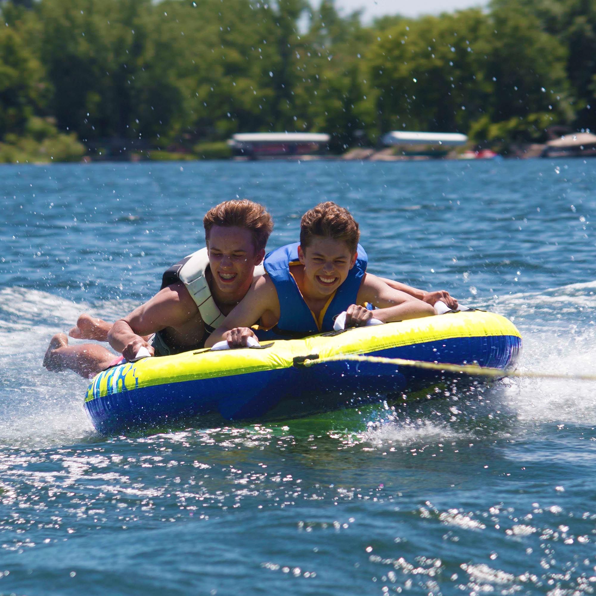 2 kids riding in Rave Sports Halo 2 Rider Towable 02825 