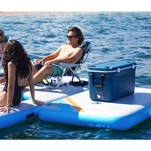 A man and a woman sitting on Solstice Watersports 10' X 8' X 8" Inflatable Rec Mesh Dock 38180