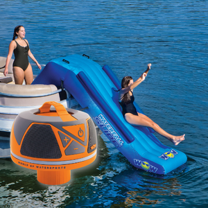 WOW Pontoon Waterfall Slide Inflatable Platform with a women slidding on it and 1 standing beside it with WOW Waterproof bluetooth speaker