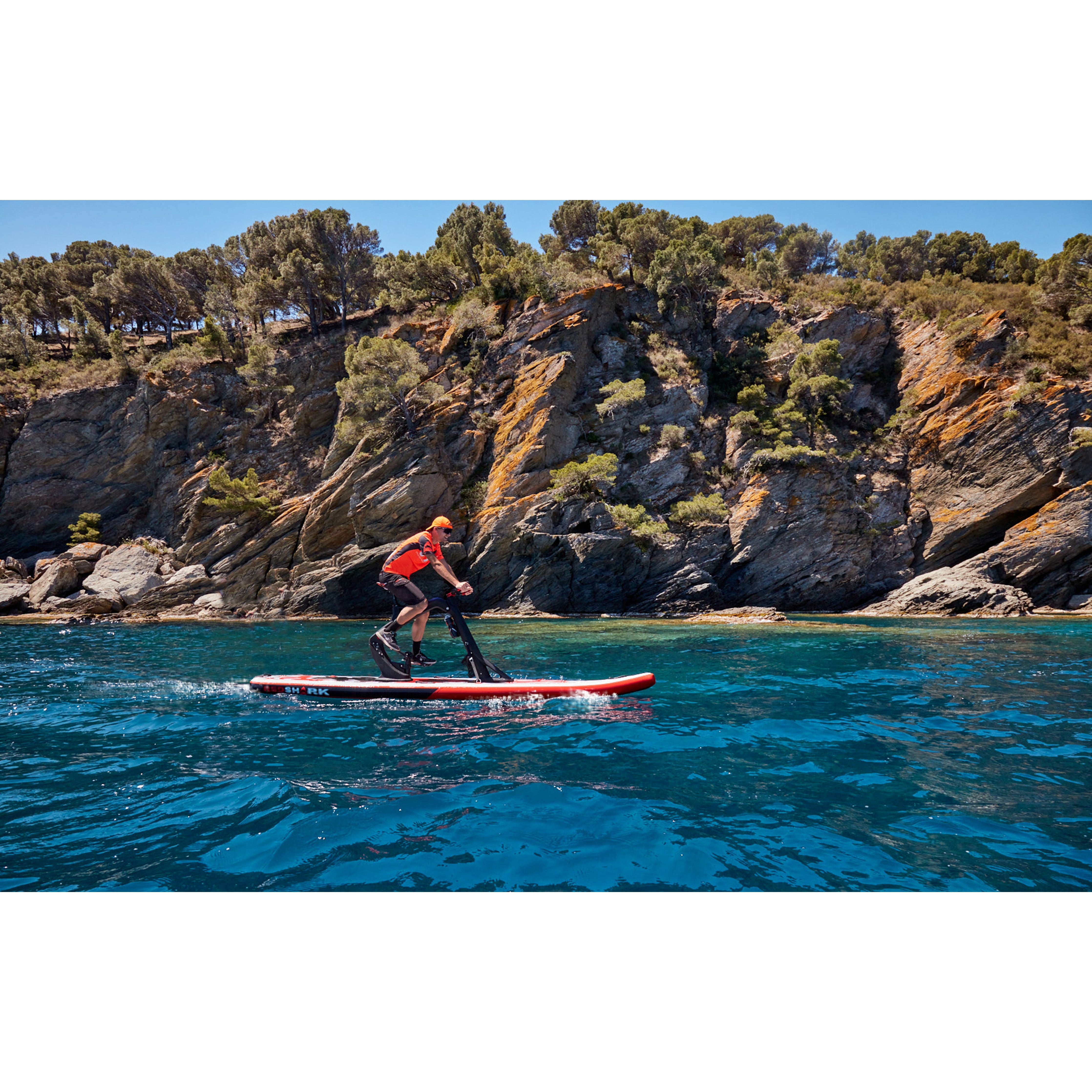 A Man Riding The Red Shark Bike Surf Fitness Water Bike