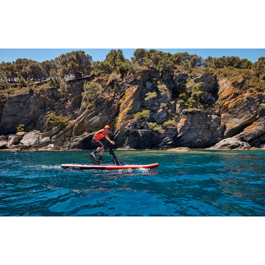 A Man Riding The Red Shark Bike Surf Fitness Water Bike