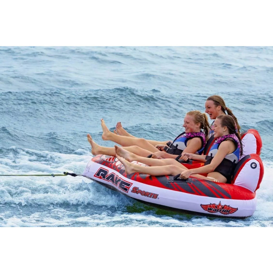 Side view of 3 women riding in Rave Sports Warrior III - 3 Rider Towable 02379