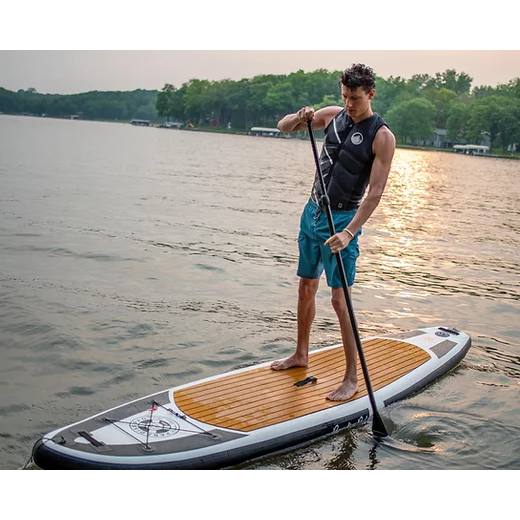 ParadisePad 10'6"x 32" Stand Up Paddleboard with a man on it