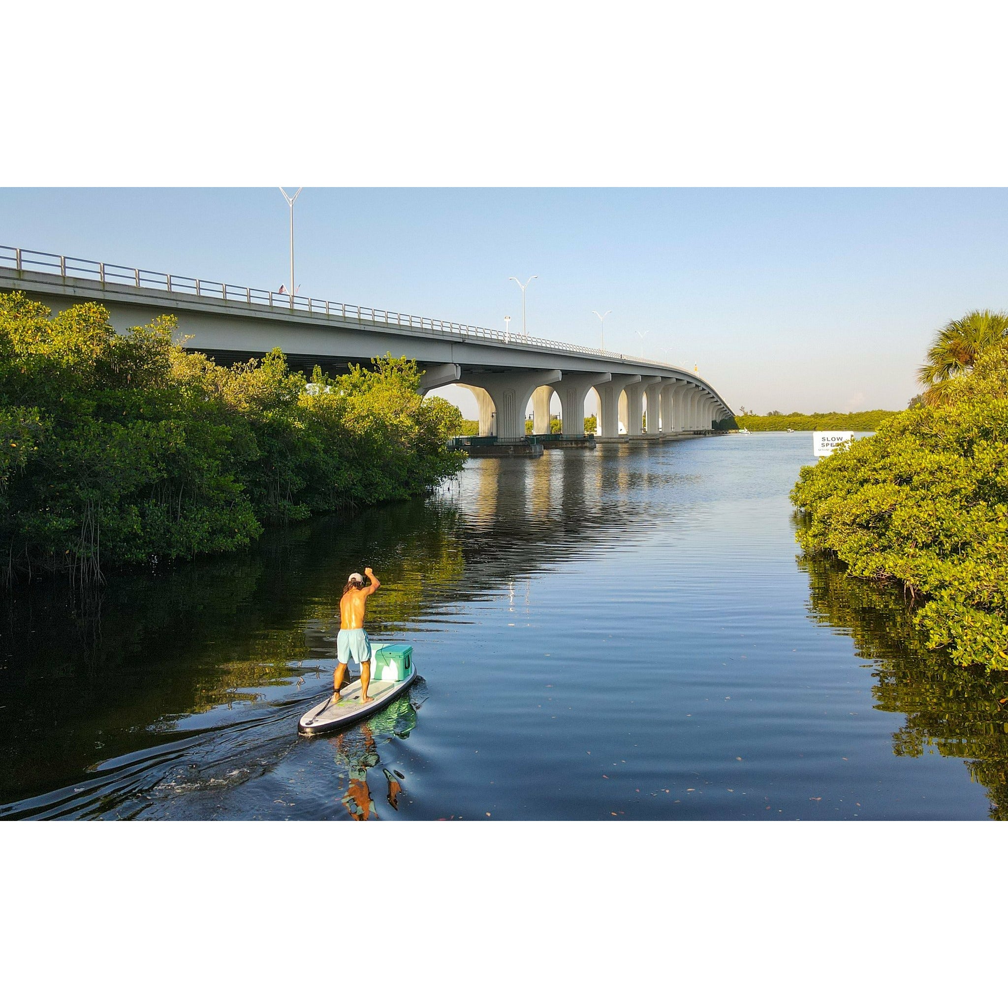 Inflatable stand up paddleboard -Man and a cooler on top of Eco Outfitters Inflatable Stand Up Paddle Board 10'6