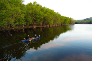 Man and woman travelling with the Merrimack Canoes Sanborn + Merrimack Driftless Canoe