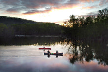 Load image into Gallery viewer, People riding a Merrimack Canoes Sanborn + Merrimack Driftless Canoe on the lake