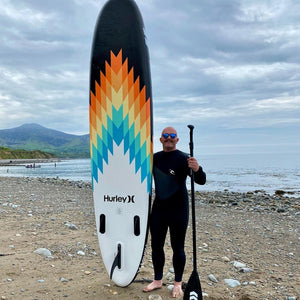 Inflatable Stand Up Paddleboard - Man standing beside the Hurley Advantage 10'6" iSUP Outsider HUR-003 