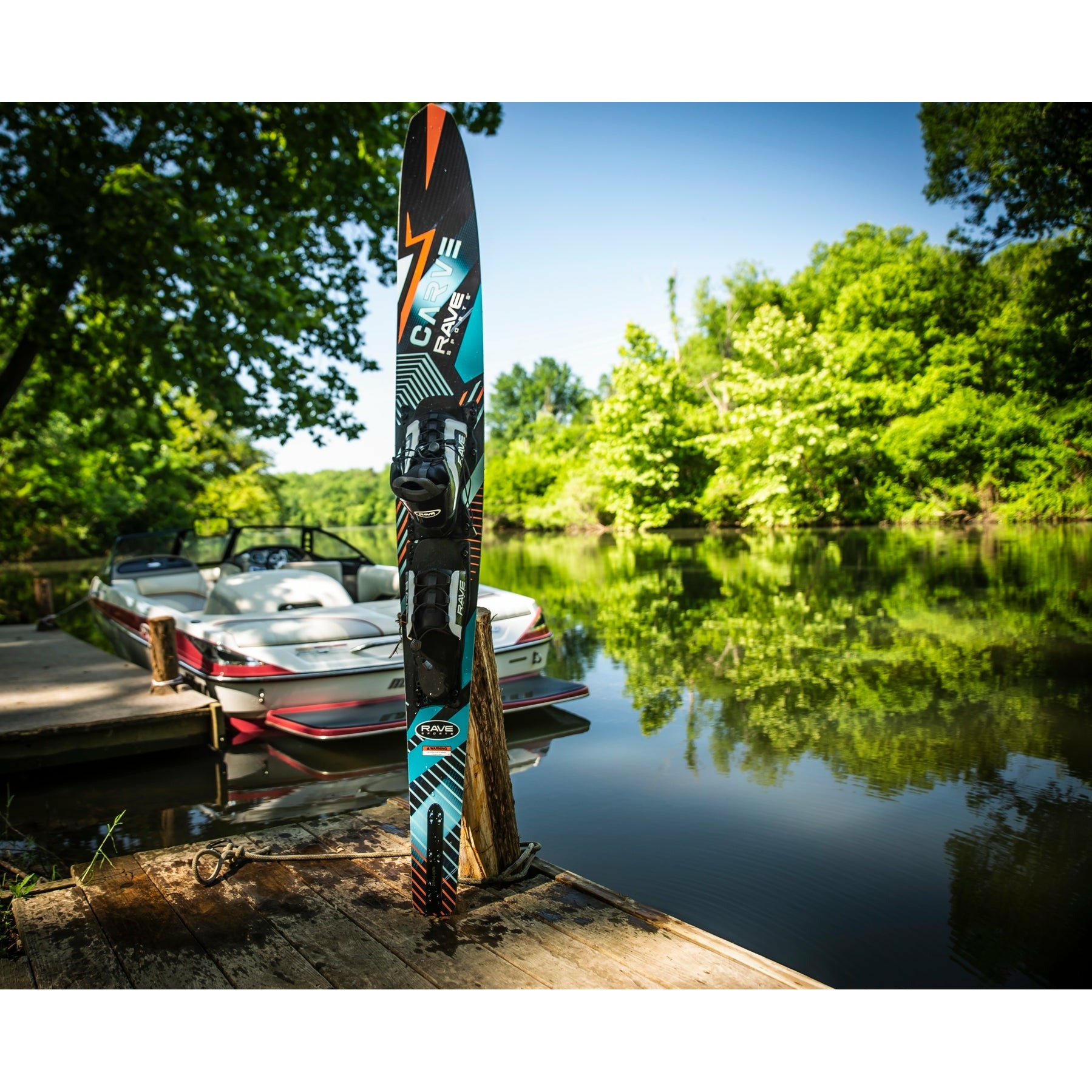 Rave Carve Slalom Water Ski standing in a lake