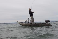 Man standing on the boat with the Scout Inflatables Stabilizer Bar