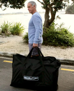 Man carrying the Scout Inflatables 430 Scout 14’ x 3.5” inside the bag