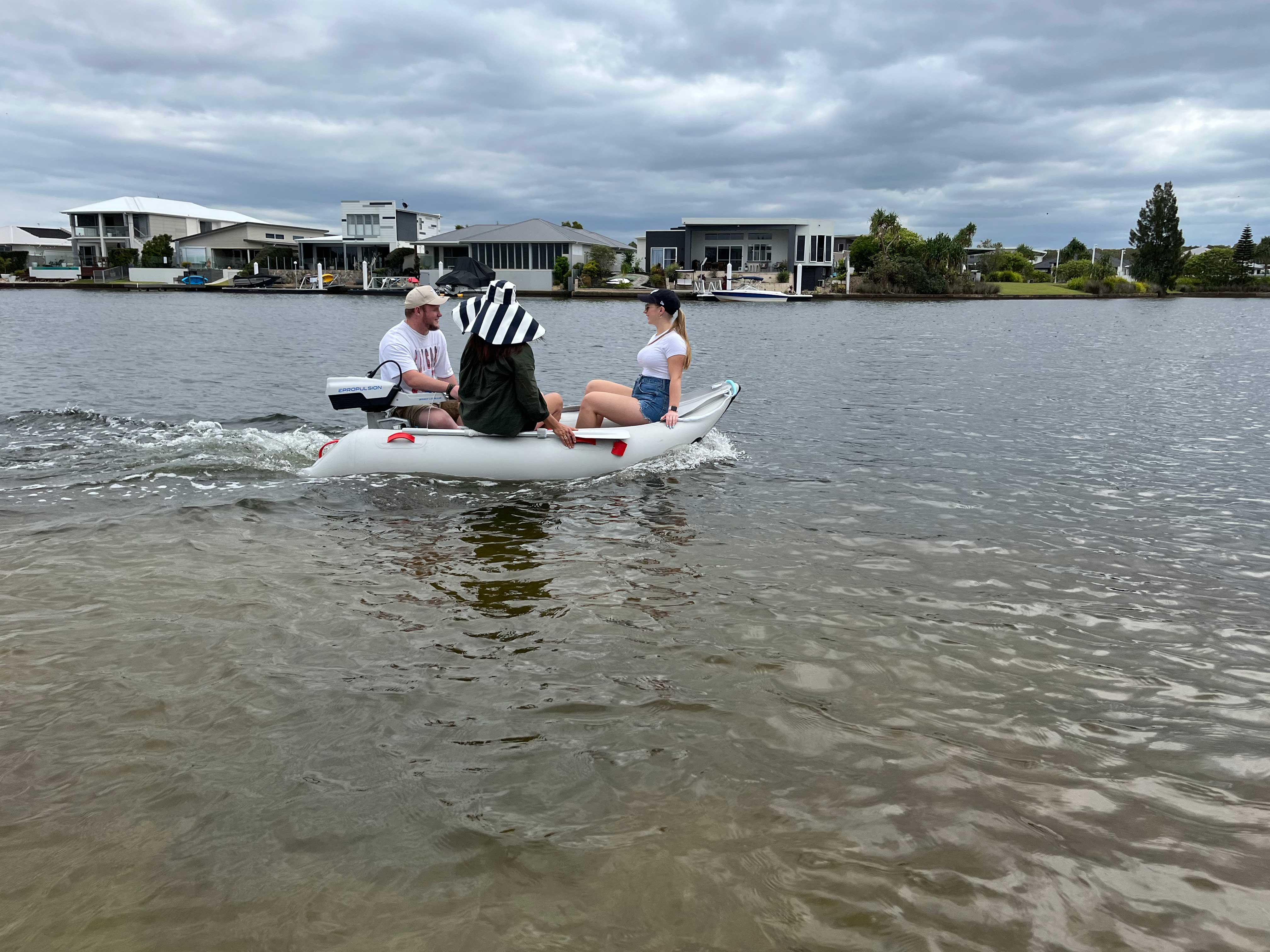 Three people riding the Scout Inflatables 245 Scout