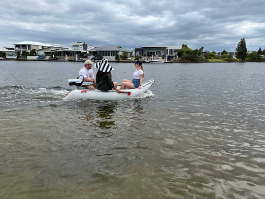 Three people riding the Scout Inflatables 245 Scout