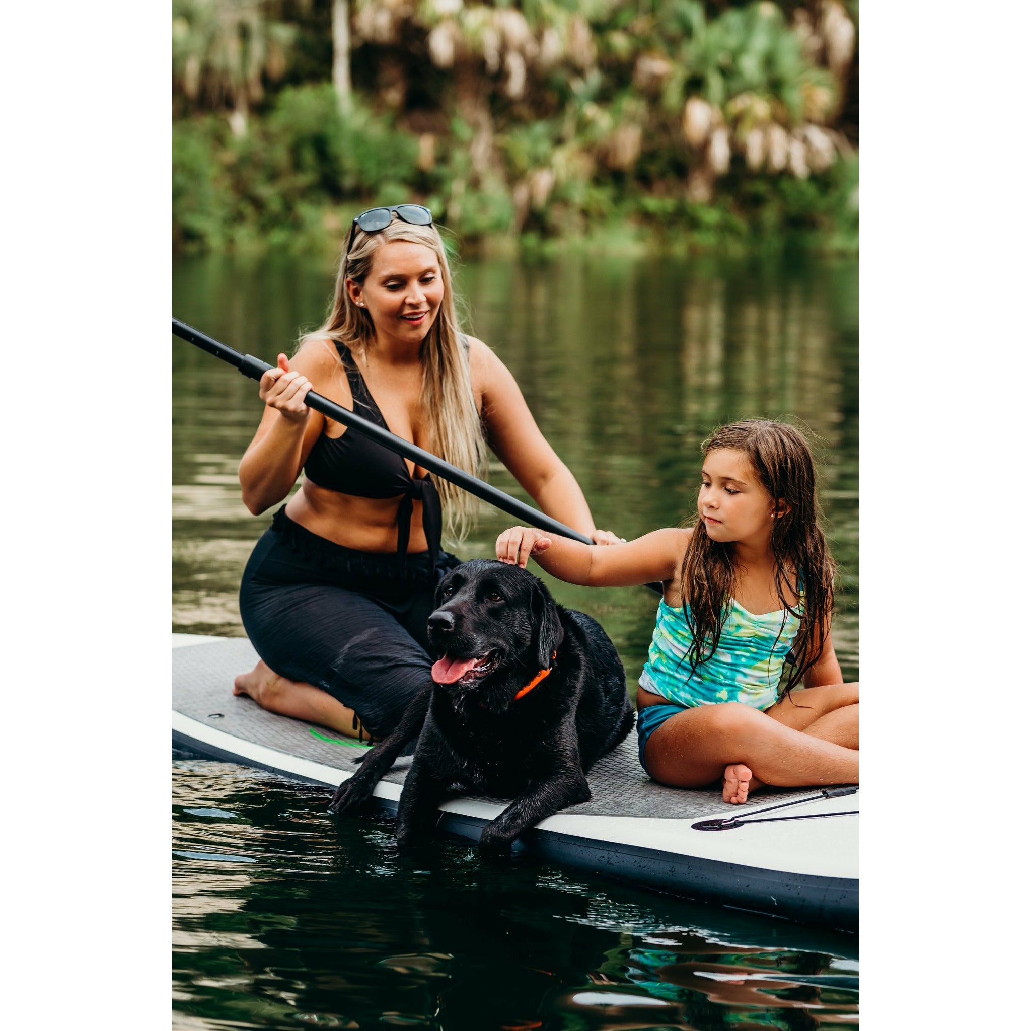 Inflatable stand up paddleboard - mother and daughter with their dog on top of Eco Outfitters Inflatable Stand Up Paddle Board 10'6 grey 