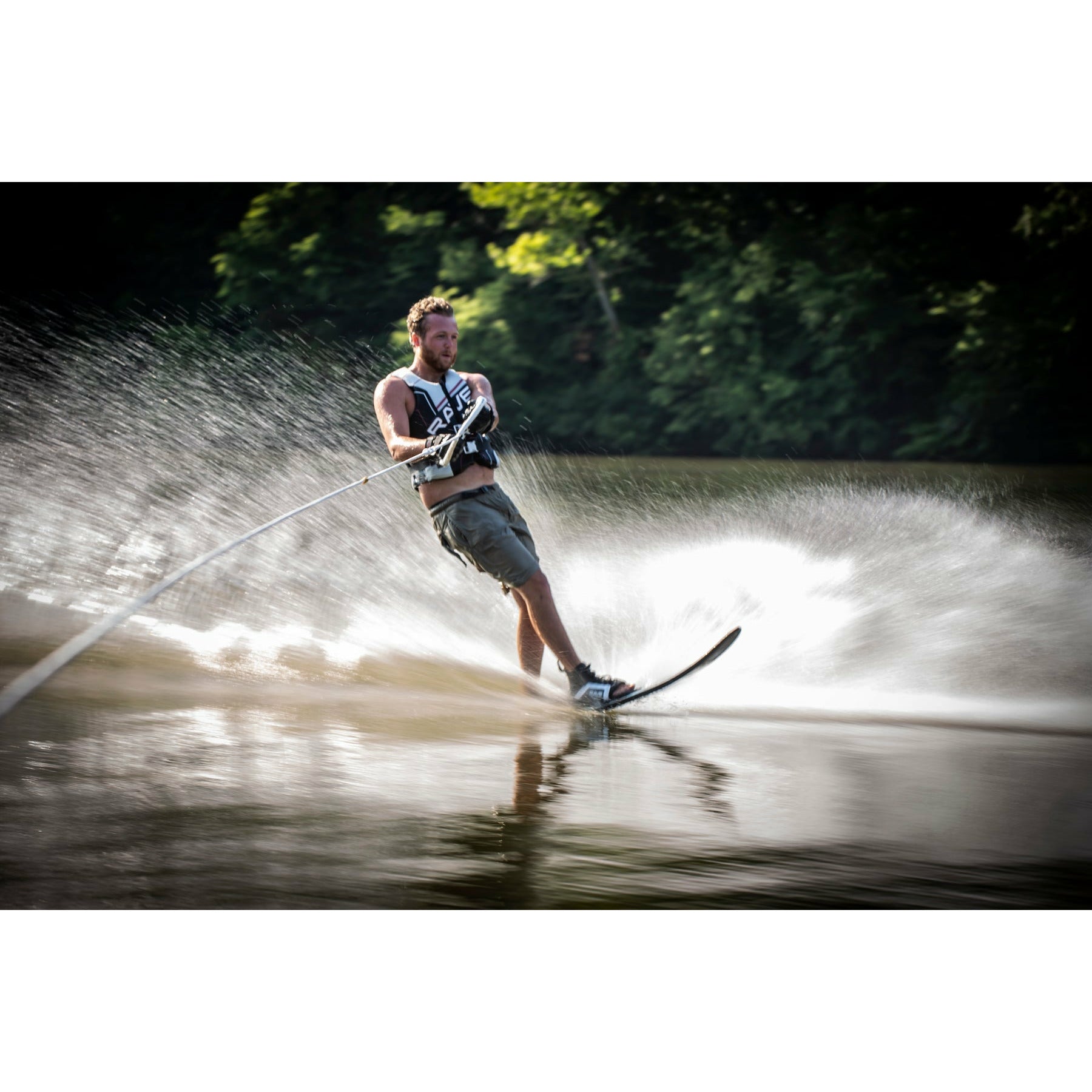 A man skiing using Rave Carve Slalom Water Ski