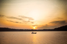 Load image into Gallery viewer, Man canoeing with the Merrimack Canoes Sanborn + Merrimack Pickwick Canoe and the sunset