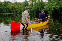 Load image into Gallery viewer, Men with some stuffs loaded in the Merrimack Canoes Prospector - 16&#39; Canoe