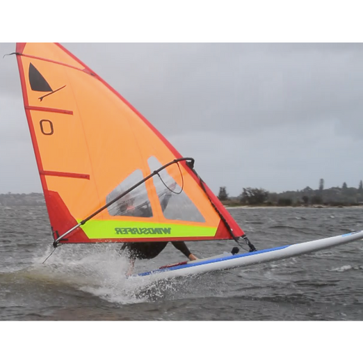 Windsurf Board -Man windsurfing with the Aerotech Sails 2021 Windsurfer LT School Windsurf Board on a windy and not so calm water