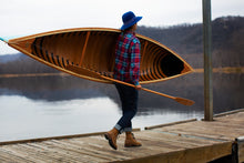 Load image into Gallery viewer, Woman carrying a paddle and the Merrimack Canoes Solitaire 11&#39;9&quot; Solo Canoe