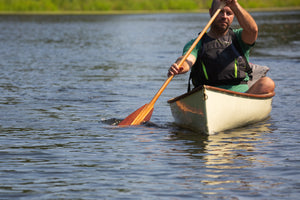 Man paddling with the Merrimack Canoes Solitaire 11'9" Solo Canoe