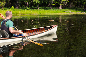 Man canoeing with the Merrimack Canoes Solitaire 11'9" Solo Canoe