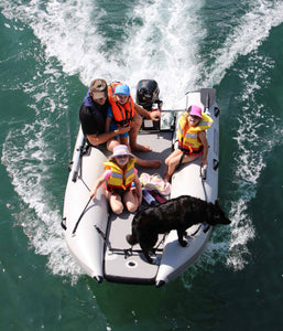 Man and three kids with the dog riding the Takacat T300LX Inflatable Boat
