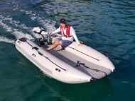 Man riding the Takacat T340LX Inflatable Boat