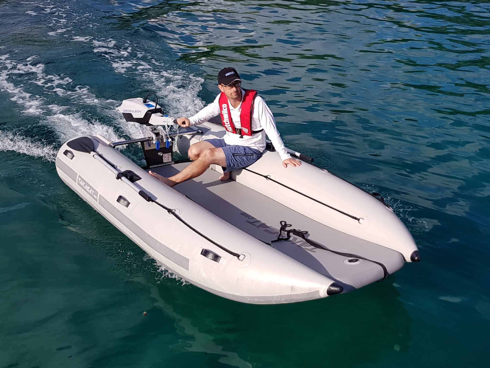 Man riding the Takacat T460LX Inflatable Boat