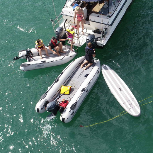 family boarding the vessel with Takacat Inflatable Boats and paddle board at the back