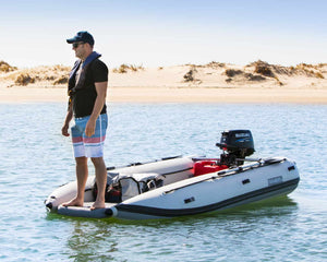 Man standing on the Takacat T380LX Inflatable Boat