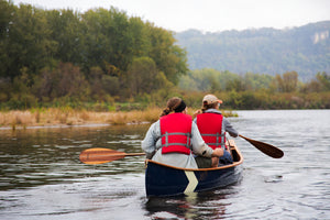 two people riding on a Merrimack Canoes Tennessean 14'6" Canoe at the lake