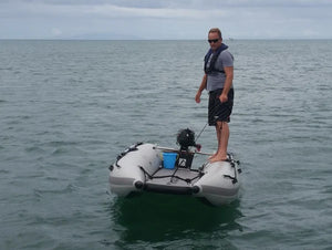 Man standing at the side of the Takacat T420LX Inflatable Boat