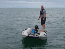 Load image into Gallery viewer, Man standing at the side of the Takacat T460LX Inflatable Boat